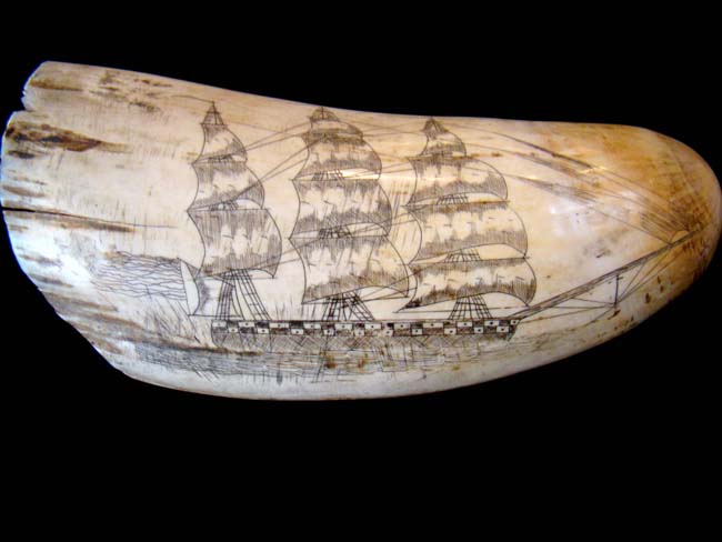 An attractive 'Liberty' themed 'sag harbor' style scrimshawed whale's tooth depicting a soldier flanked by a pair of cannons with four American flags in the background — image 2